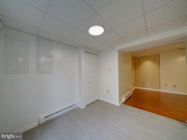 9407 7th St N, Laurel, MD 20723 - finished below grade area featuring electric panel, a baseboard radiator, baseboards, and a drop ceiling
