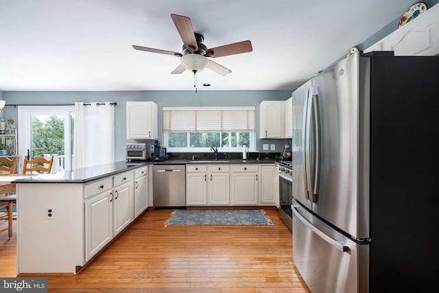 14 Baron Ct, Stafford, VA 22554 - kitchen featuring stainless steel appliances, a peninsula, plenty of natural light, and light wood finished floors