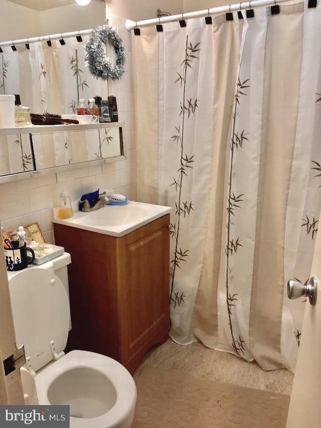 4600 Duke St Unit 1208, Alexandria, VA 22304 - full bathroom featuring toilet, tile walls, tasteful backsplash, and vanity