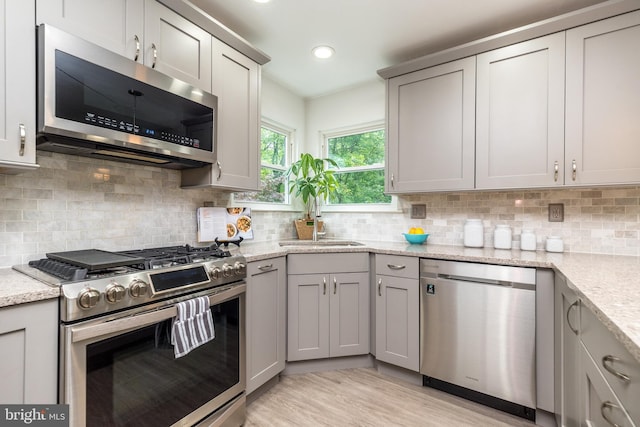 256 Rock Run Rd, Yardley, PA 19067 - kitchen with appliances with stainless steel finishes, gray cabinetry, decorative backsplash, light stone countertops, and recessed lighting