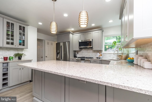 256 Rock Run Rd, Yardley, PA 19067 - kitchen featuring stainless steel appliances, gray cabinets, a sink, light stone counters, and tasteful backsplash