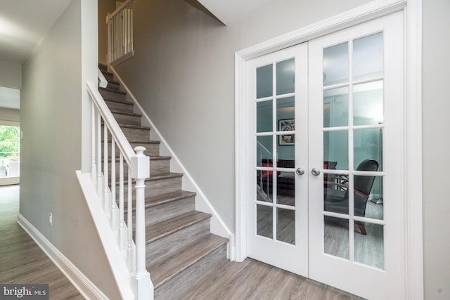 256 Rock Run Rd, Yardley, PA 19067 - stairway featuring french doors, wood finished floors, and baseboards