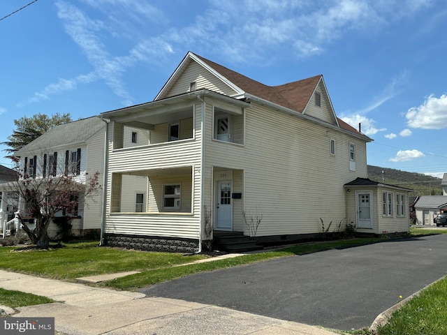203 4th Ave, Burnham, PA 17009 - view of side of home featuring a balcony, entry steps, and a lawn