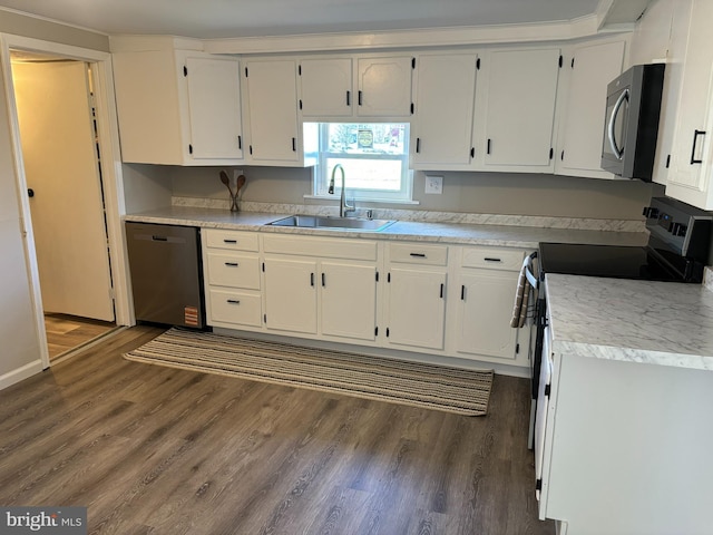 203 4th Ave, Burnham, PA 17009 - kitchen with stainless steel appliances, a sink, dark wood-style flooring, and white cabinetry