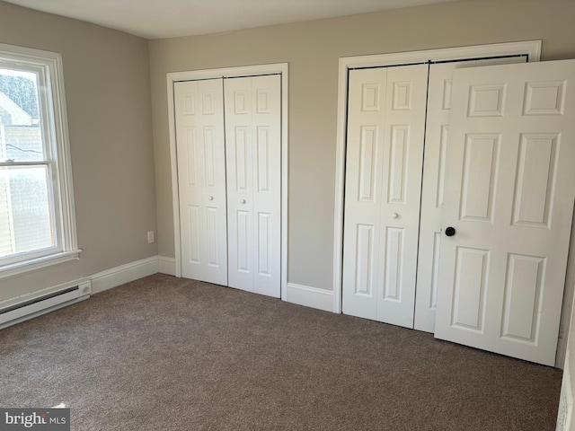 203 4th Ave, Burnham, PA 17009 - unfurnished bedroom featuring multiple closets, carpet floors, multiple windows, and a baseboard heating unit