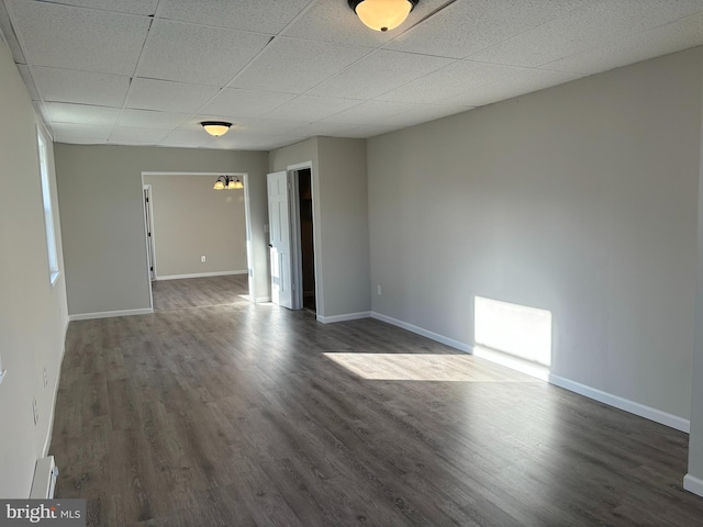 203 4th Ave, Burnham, PA 17009 - unfurnished room featuring a drop ceiling, dark wood-style flooring, baseboards, and a baseboard heating unit