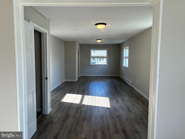 203 4th Ave, Burnham, PA 17009 - unfurnished room featuring a baseboard radiator, a paneled ceiling, dark wood-style flooring, and baseboards
