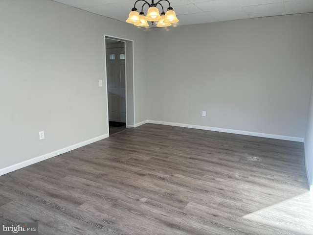 203 4th Ave, Burnham, PA 17009 - spare room featuring a chandelier, dark wood-type flooring, and baseboards