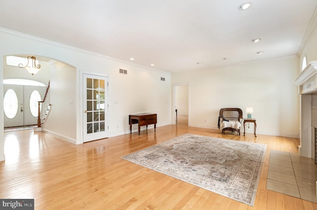 148 Lawn Rd, Palmyra, PA 17078 - living area with ornamental molding, light wood finished floors, a fireplace with flush hearth, arched walkways, and recessed lighting