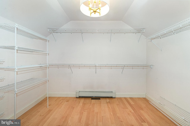 148 Lawn Rd, Palmyra, PA 17078 - spacious closet featuring baseboard heating, wood finished floors, a chandelier, and lofted ceiling