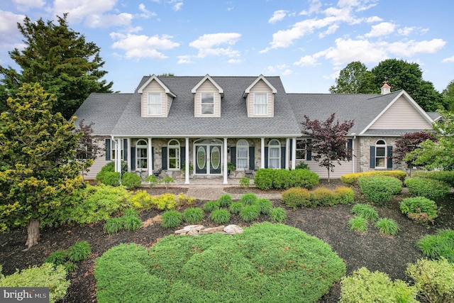 148 Lawn Rd, Palmyra, PA 17078 - new england style home featuring a porch, stone siding, and a shingled roof