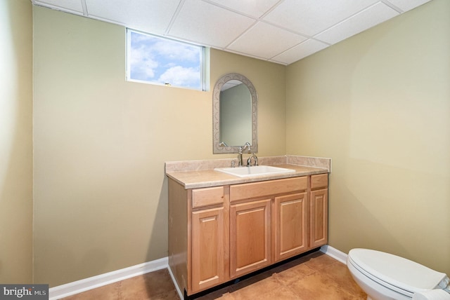148 Lawn Rd, Palmyra, PA 17078 - half bath featuring a drop ceiling, vanity, toilet, tile patterned flooring, and baseboards