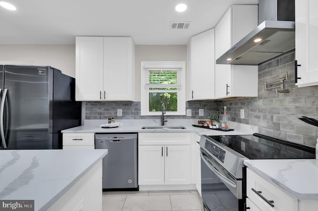 14901 Running Ridge Ln, Silver Spring, MD 20906 - kitchen featuring appliances with stainless steel finishes, a sink, wall chimney range hood, light stone countertops, and recessed lighting