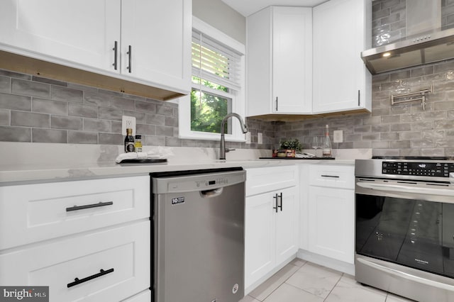 14901 Running Ridge Ln, Silver Spring, MD 20906 - kitchen with stainless steel appliances, wall chimney exhaust hood, decorative backsplash, and white cabinetry