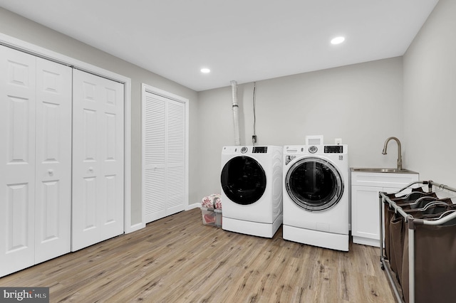 14901 Running Ridge Ln, Silver Spring, MD 20906 - laundry area with washing machine and dryer, cabinet space, light wood-type flooring, recessed lighting, and baseboards