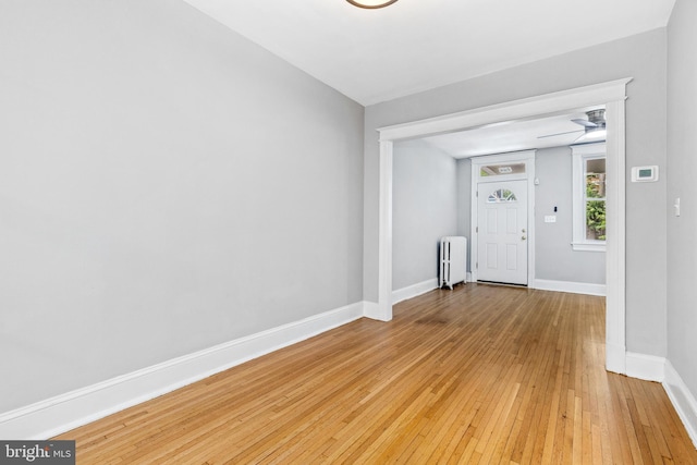 616 Hamilton St NW, Washington, DC 20011 - foyer entrance with radiator, light wood-style floors, baseboards, and a ceiling fan