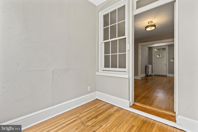 616 Hamilton St NW, Washington, DC 20011 - spare room featuring radiator heating unit, light wood finished floors, and baseboards