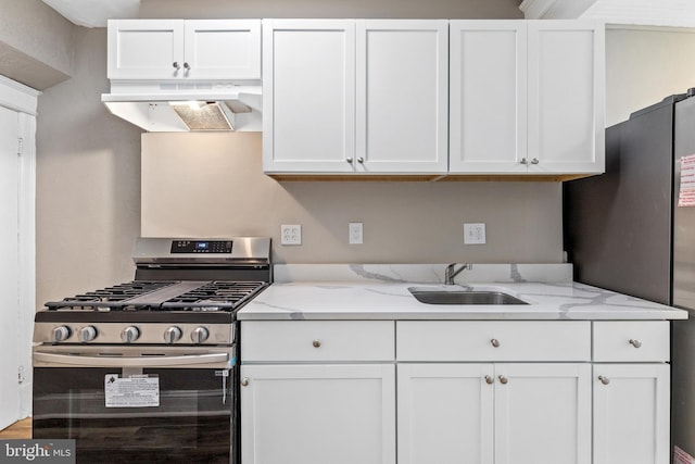 616 Hamilton St NW, Washington, DC 20011 - kitchen featuring appliances with stainless steel finishes, a sink, premium range hood, white cabinetry, and light stone counters