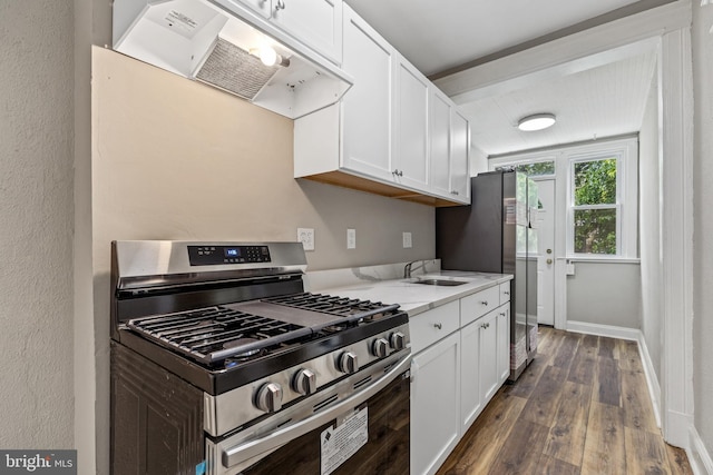 616 Hamilton St NW, Washington, DC 20011 - kitchen featuring stainless steel appliances, exhaust hood, dark wood-type flooring, white cabinetry, and a sink