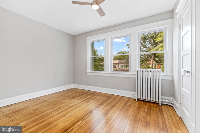 616 Hamilton St NW, Washington, DC 20011 - spare room with radiator heating unit, baseboards, light wood-style flooring, and ceiling fan