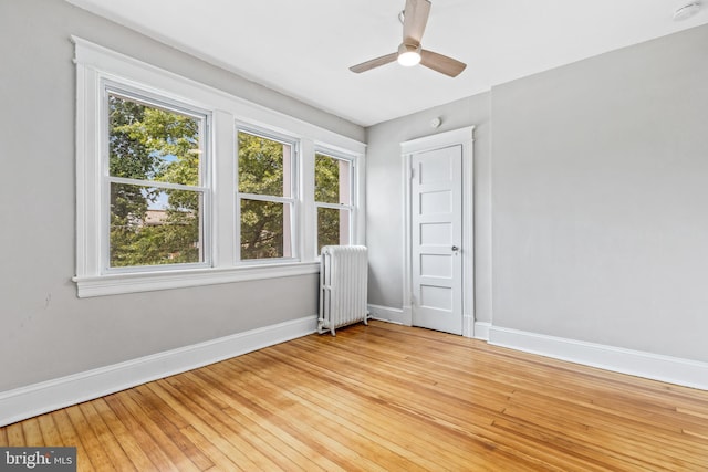 616 Hamilton St NW, Washington, DC 20011 - spare room featuring radiator, baseboards, a smoke detector, light wood-style flooring, and ceiling fan