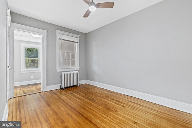616 Hamilton St NW, Washington, DC 20011 - empty room featuring radiator, ceiling fan, hardwood / wood-style floors, and baseboards
