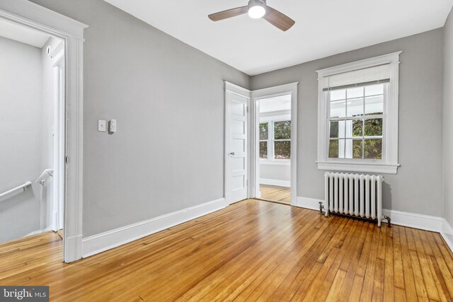616 Hamilton St NW, Washington, DC 20011 - unfurnished room with radiator heating unit, baseboards, ceiling fan, and wood-type flooring