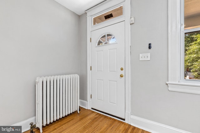 616 Hamilton St NW, Washington, DC 20011 - entryway with radiator, baseboards, and light wood finished floors