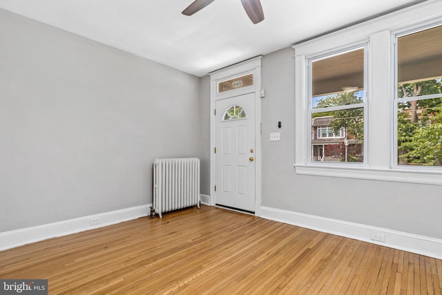 616 Hamilton St NW, Washington, DC 20011 - foyer entrance featuring radiator, a ceiling fan, light wood-style flooring, and baseboards