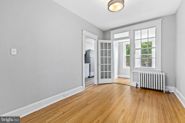 616 Hamilton St NW, Washington, DC 20011 - spare room featuring radiator heating unit, baseboards, and light wood-style floors