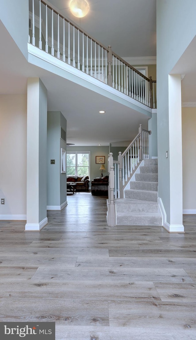 6224 Parkview Ct, Elkridge, MD 21075 - staircase with wood finished floors, baseboards, a towering ceiling, and recessed lighting