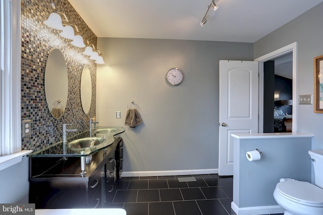 6224 Parkview Ct, Elkridge, MD 21075 - full bathroom with double vanity, tile patterned floors, baseboards, toilet, and rail lighting