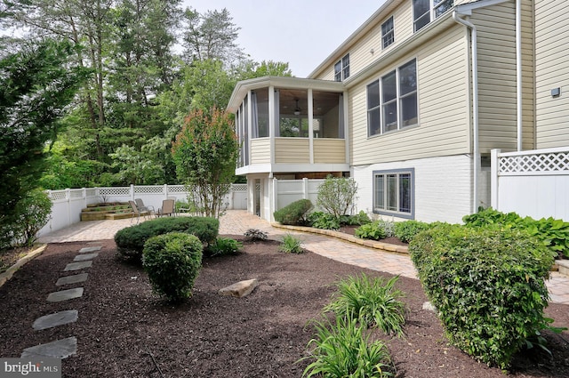 6224 Parkview Ct, Elkridge, MD 21075 - view of side of property with a patio area, a sunroom, brick siding, and a ceiling fan