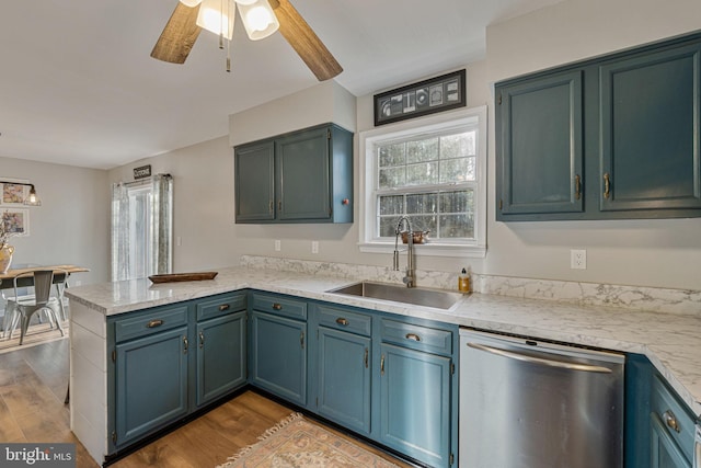 19446 Heather Ln, Orange, VA 22960 - kitchen with stainless steel dishwasher, a sink, a peninsula, light countertops, and wood finished floors
