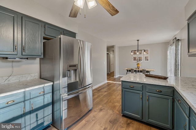 19446 Heather Ln, Orange, VA 22960 - kitchen featuring stainless steel fridge, a ceiling fan, light countertops, dark wood-style floors, and decorative light fixtures