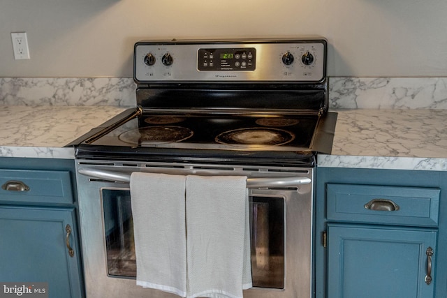 19446 Heather Ln, Orange, VA 22960 - kitchen with stainless steel range with electric stovetop, blue cabinetry, and light countertops