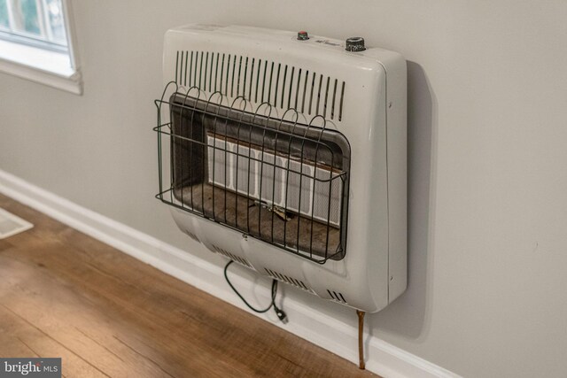 19446 Heather Ln, Orange, VA 22960 - detailed view of heating unit, baseboards, and wood finished floors