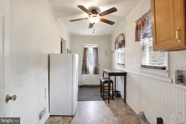 526 N 3rd St, Wormleysburg, PA 17043 - kitchen with freestanding refrigerator, healthy amount of natural light, ceiling fan, light tile patterned floors, and wainscoting