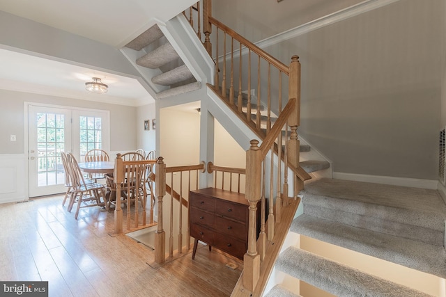 21008 Strawrick Ter, Ashburn, VA 20147 - stairway with wood finished floors, a wainscoted wall, and crown molding
