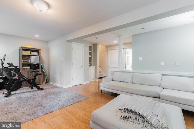 21008 Strawrick Ter, Ashburn, VA 20147 - living area with light wood finished floors, stairs, baseboards, ornate columns, and recessed lighting
