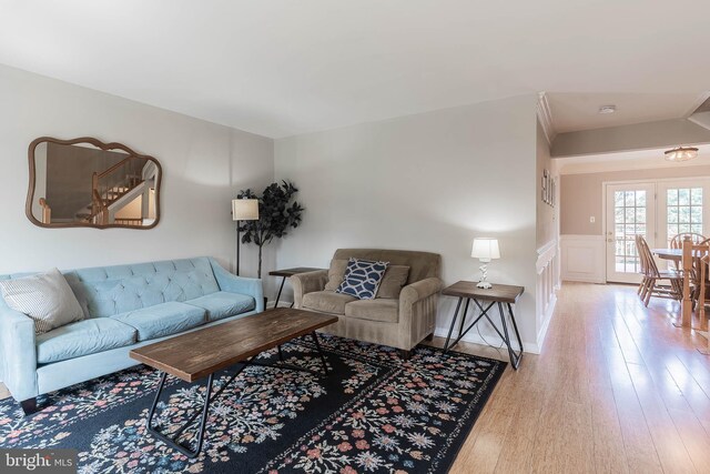 21008 Strawrick Ter, Ashburn, VA 20147 - living room with wood finished floors, a wainscoted wall, and a decorative wall
