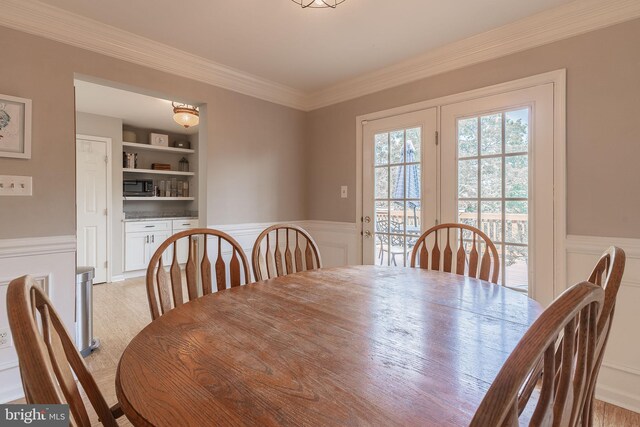 21008 Strawrick Ter, Ashburn, VA 20147 - dining area featuring a decorative wall, built in features, wainscoting, and ornamental molding