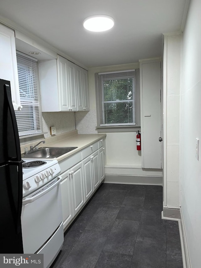 11 S Franklin St, Pottstown, PA 19464 - kitchen with white electric range, freestanding refrigerator, white cabinetry, a sink, and light countertops