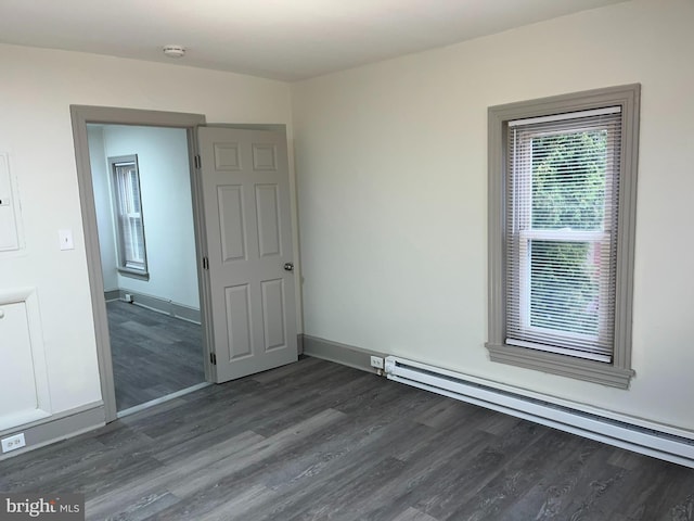 11 S Franklin St, Pottstown, PA 19464 - empty room featuring a baseboard heating unit, dark wood finished floors, a smoke detector, and baseboards
