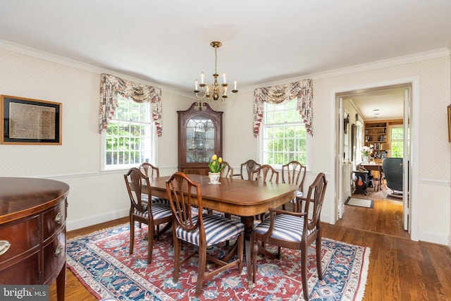 114 Bellemore Rd, Baltimore, MD 21210 - dining room featuring wallpapered walls, a chandelier, ornamental molding, wood finished floors, and baseboards