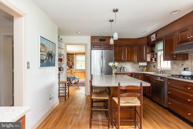 114 Bellemore Rd, Baltimore, MD 21210 - kitchen featuring open shelves, appliances with stainless steel finishes, light wood-style floors, and under cabinet range hood