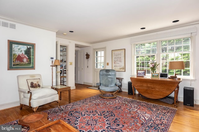 114 Bellemore Rd, Baltimore, MD 21210 - sitting room featuring wood finished floors, crown molding, and baseboards