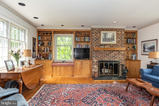 114 Bellemore Rd, Baltimore, MD 21210 - living room with wood finished floors, crown molding, plenty of natural light, a brick fireplace, and built in features