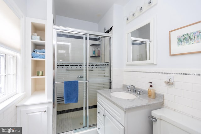 114 Bellemore Rd, Baltimore, MD 21210 - full bathroom with a shower stall, toilet, vanity, tile walls, and wainscoting
