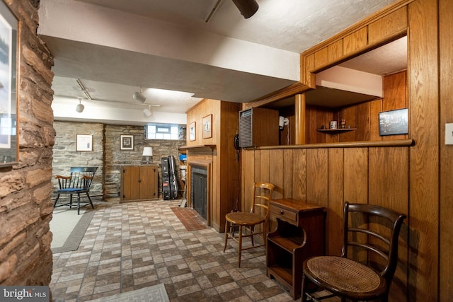 114 Bellemore Rd, Baltimore, MD 21210 - bar featuring wood walls, a fireplace, brick patterned floors, and rail lighting